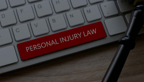 A keyboard with the space bar in red and the words “Personal Injury Law” on it, prompting you to find out what happens after a deposition.
